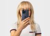 Person holding iPhone near face — Apple Newsroom privacy hero