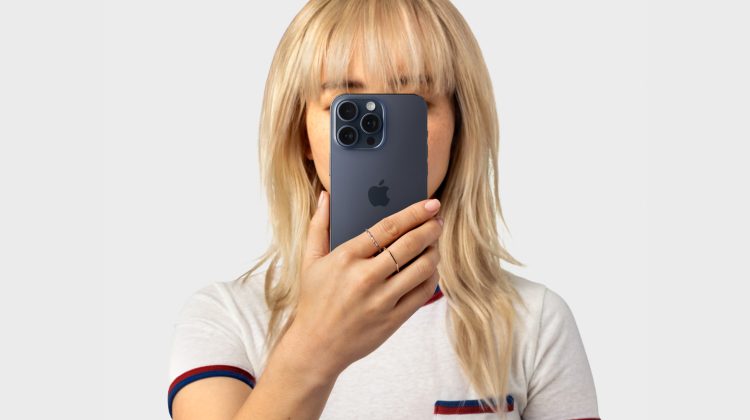 Person holding iPhone near face — Apple Newsroom privacy hero