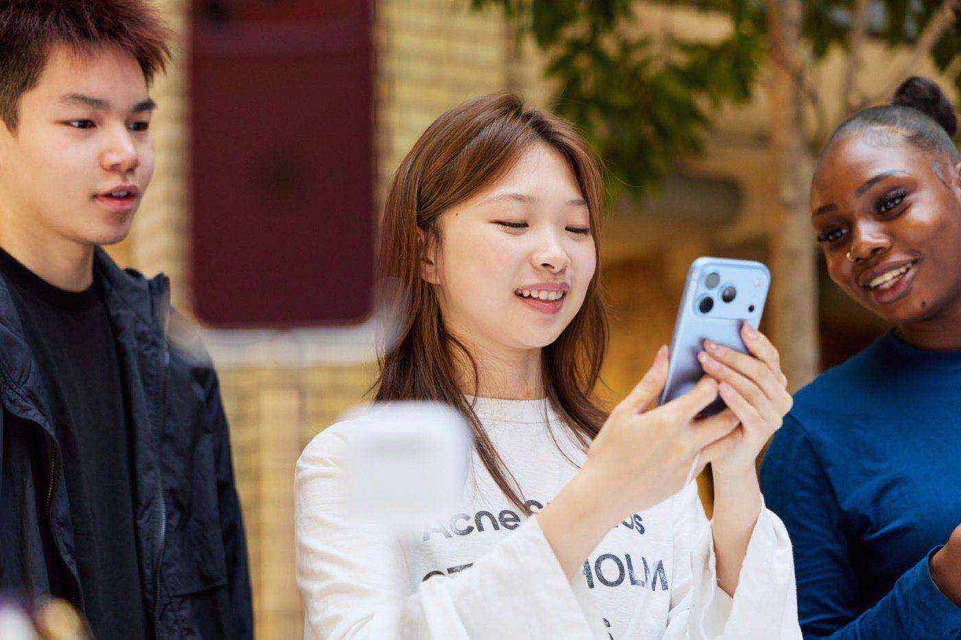 Customer holding a new iPhone 18 Pro in an Apple Store